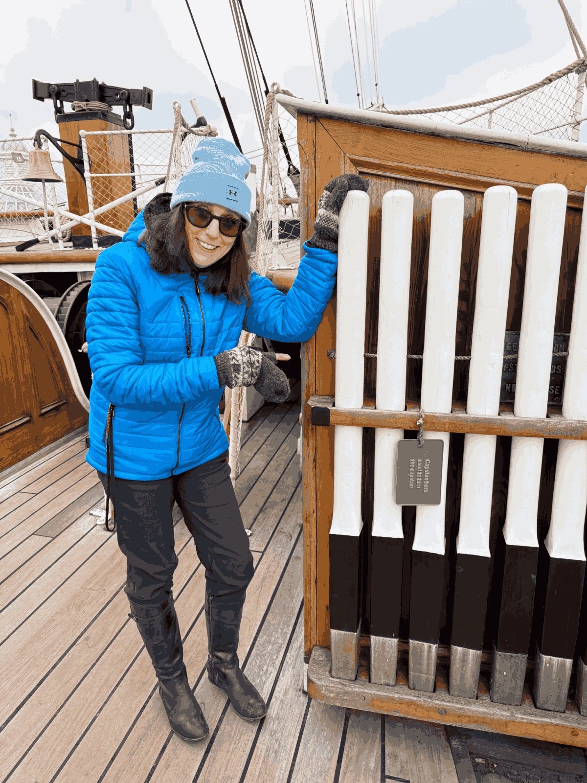 Person pointing at capstan bars on the deck of the Cutty Sark